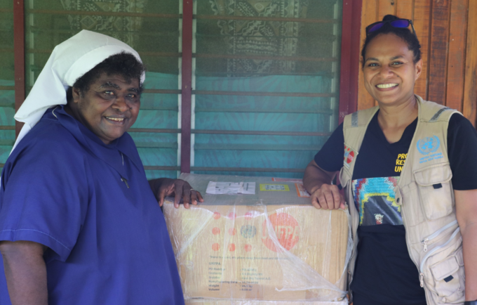 Sr. Lorraine Tarasu and UNFPA Humanitarian Officer Ms. Keren Bun with a RPI box