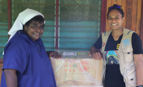Sr. Lorraine Tarasu and UNFPA Humanitarian Officer Ms. Keren Bun with a RPI box