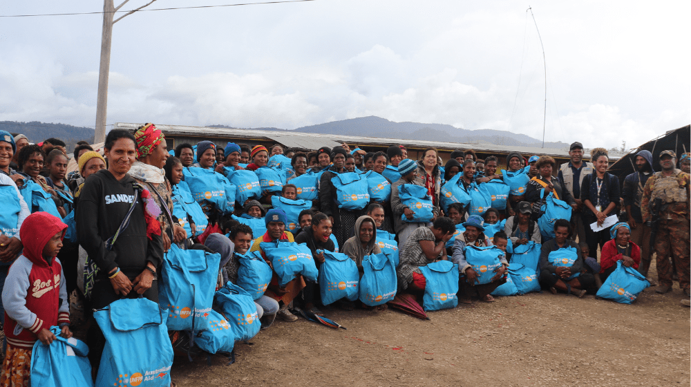 Young women and girls survivor from Mulitaka posing with their Dignity Kits.