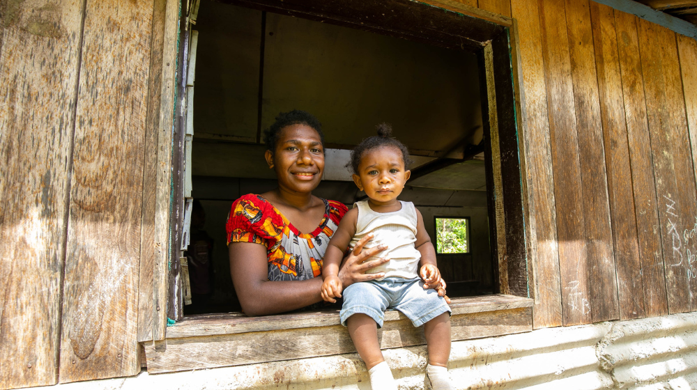 Siyen Nordo, a coffee farmer from Mangiro village, Chuave District, Simbu Province with her baby. ©UNFPA Papua New Guinea 2024