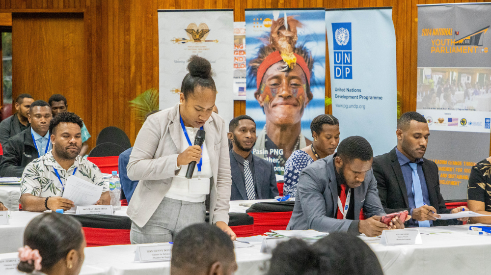 A young leader addressing the audience during the Mock Youth Parliament