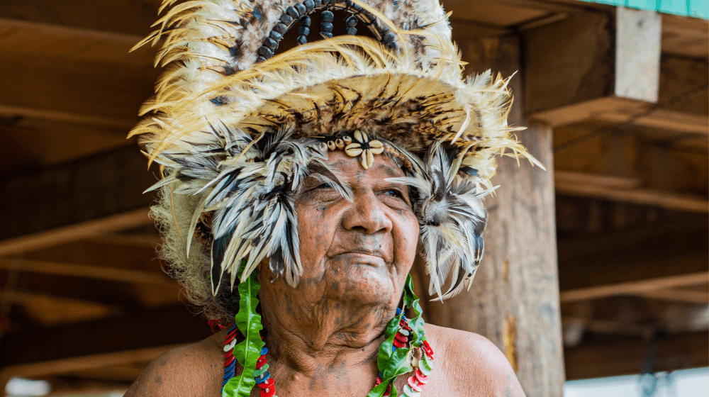 Older woman from Central Province, Papua New Guinea, in traditional dress looking into middle distance.