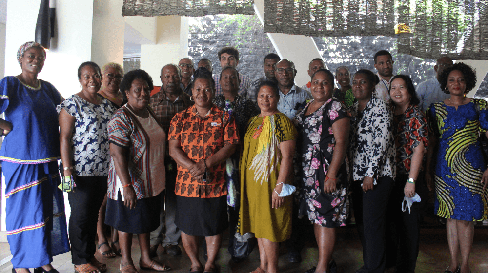 Group of 20 people pose for photo.