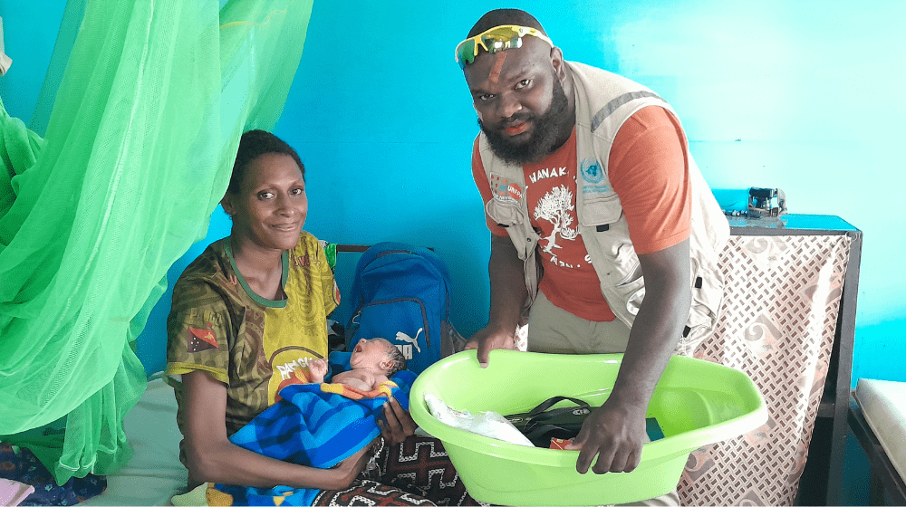 Jayda Wedjor receiving the Dignity Kit from a UNFPA staff