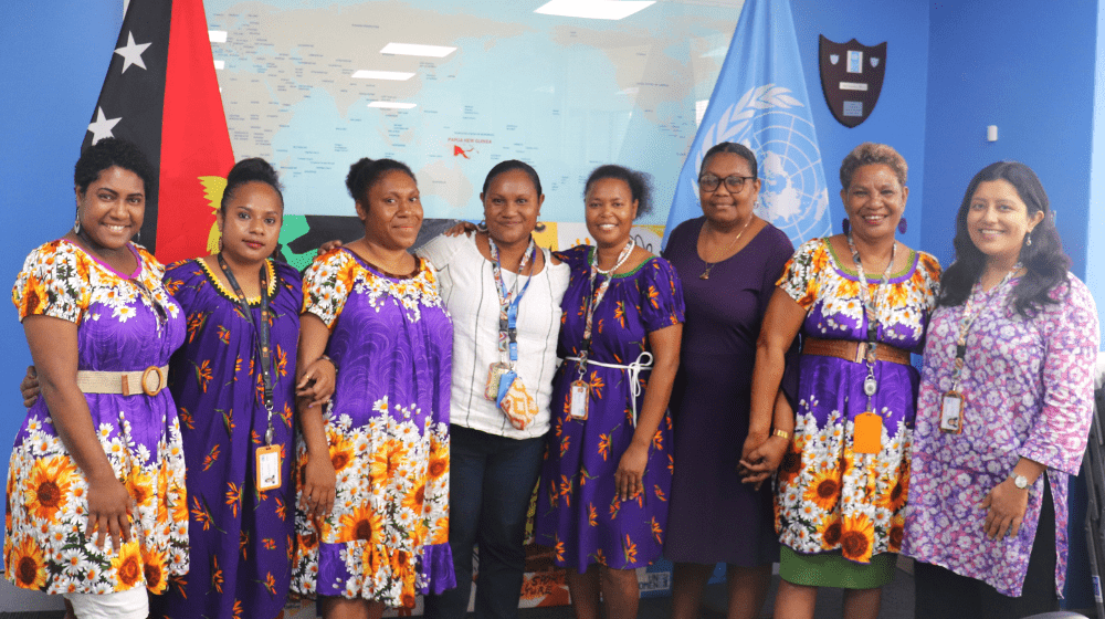 UNFPA CO women in purple celebrating International Women's Day