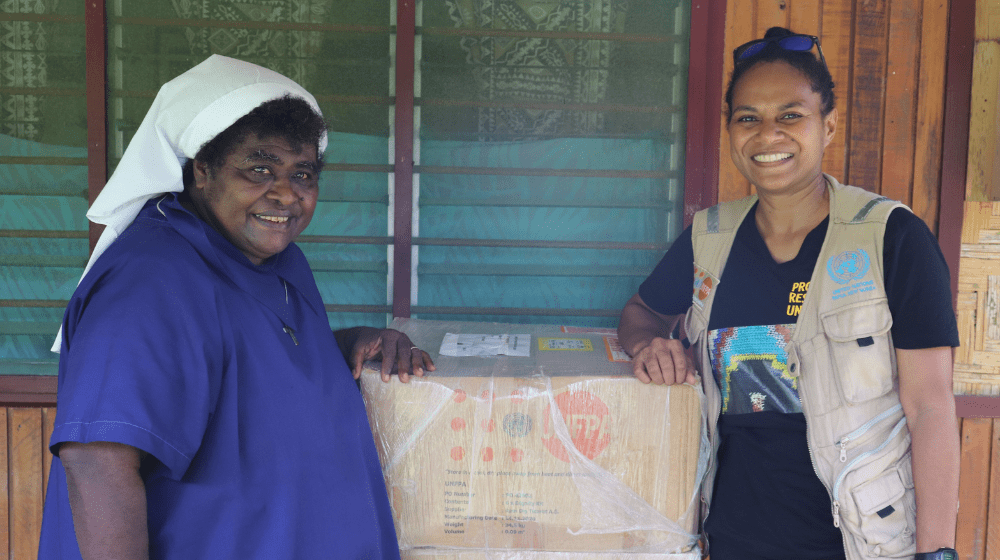 Sr. Lorraine Tarasu and UNFPA Humanitarian Officer Ms. Keren Bun with a RPI box